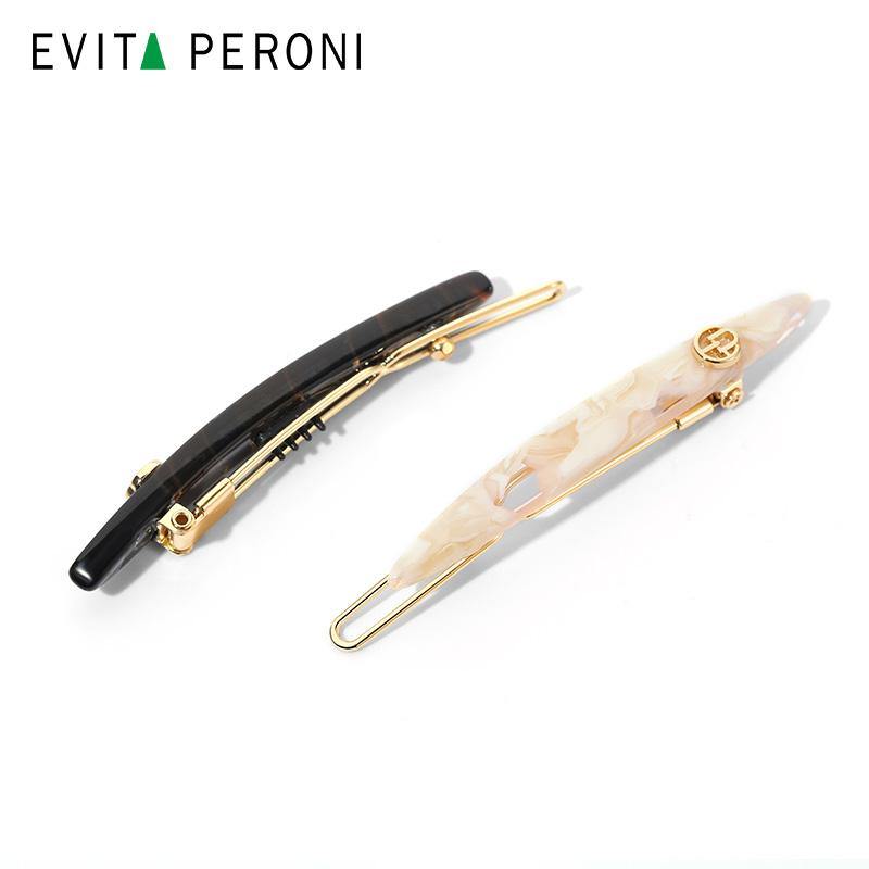 Two elegant curved hair barrettes, one black and gold, one marbled beige and gold, on white background.