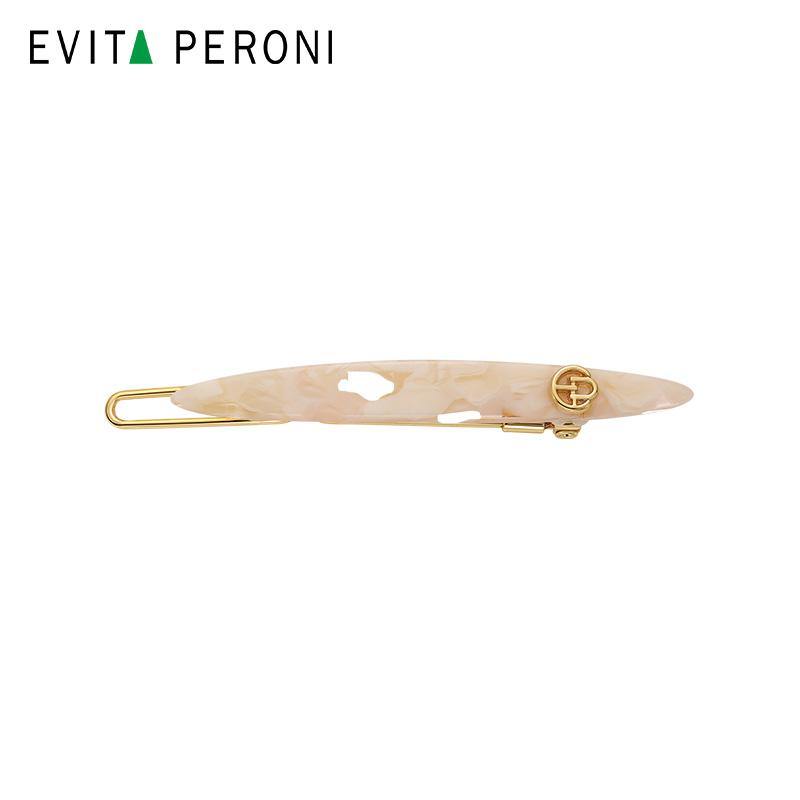 Elegant beige tortoiseshell hair barrette with gold metal clip on white background