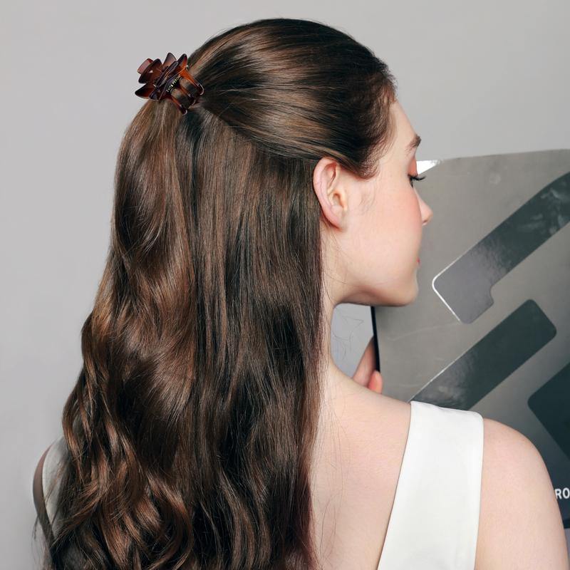 Woman with long wavy hair wearing a brown claw clip, showcasing elegant hair accessory